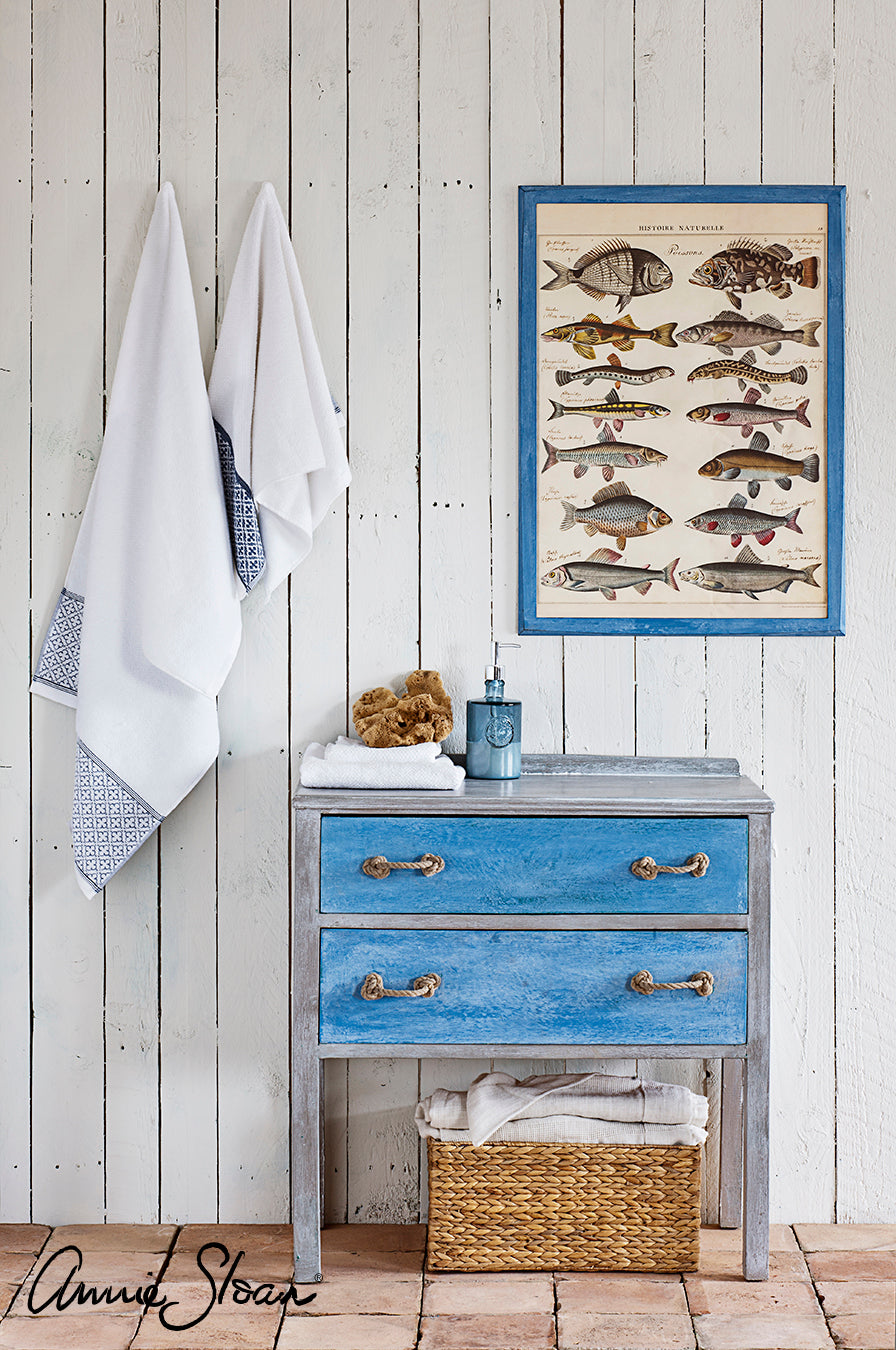 Coastal bathroom with a blue cabinet